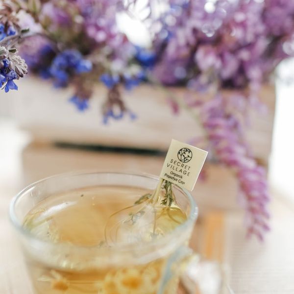 Person enjoying a healthy herbal tea in a bright room